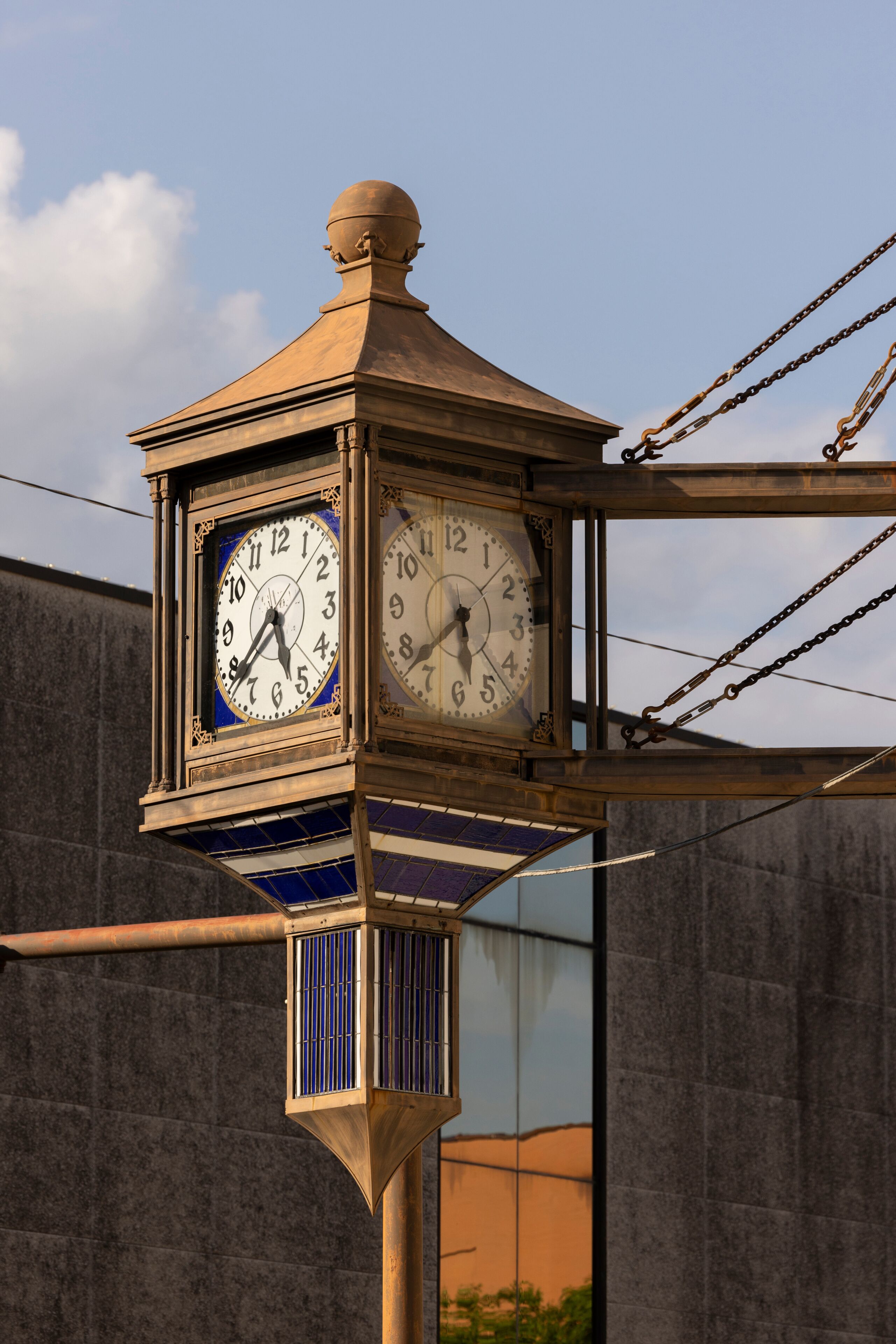 Monroe, Louisiana, USA - April 4, 2024: Afternoon sunlight shines on a vintage clock and historic buildings of downtown Monroe.