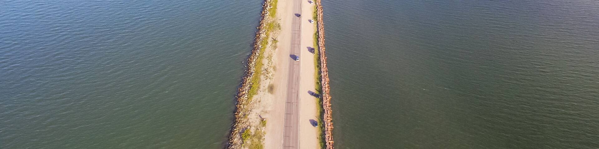 Panorama aerial view famous Texas City Dike, a levee that projects nearly 5miles south-east into mouth of Galveston Bay. It was designed to reduce the impact of sediment accumulation along lower Bay