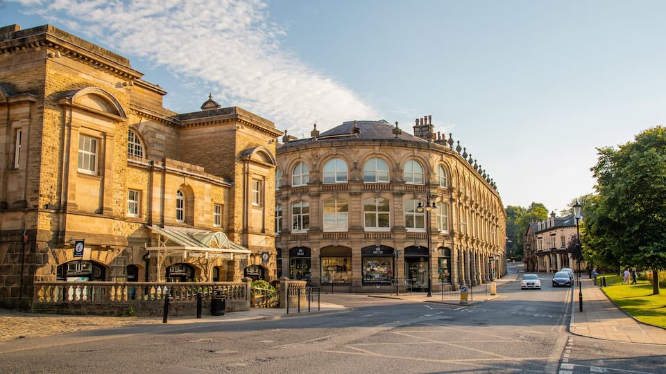 A street with historic buildings, a café, and a tram stop.