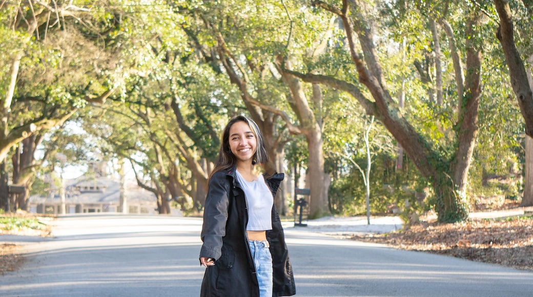 Young Woman Walking Down the Street in a tunnel of Trees