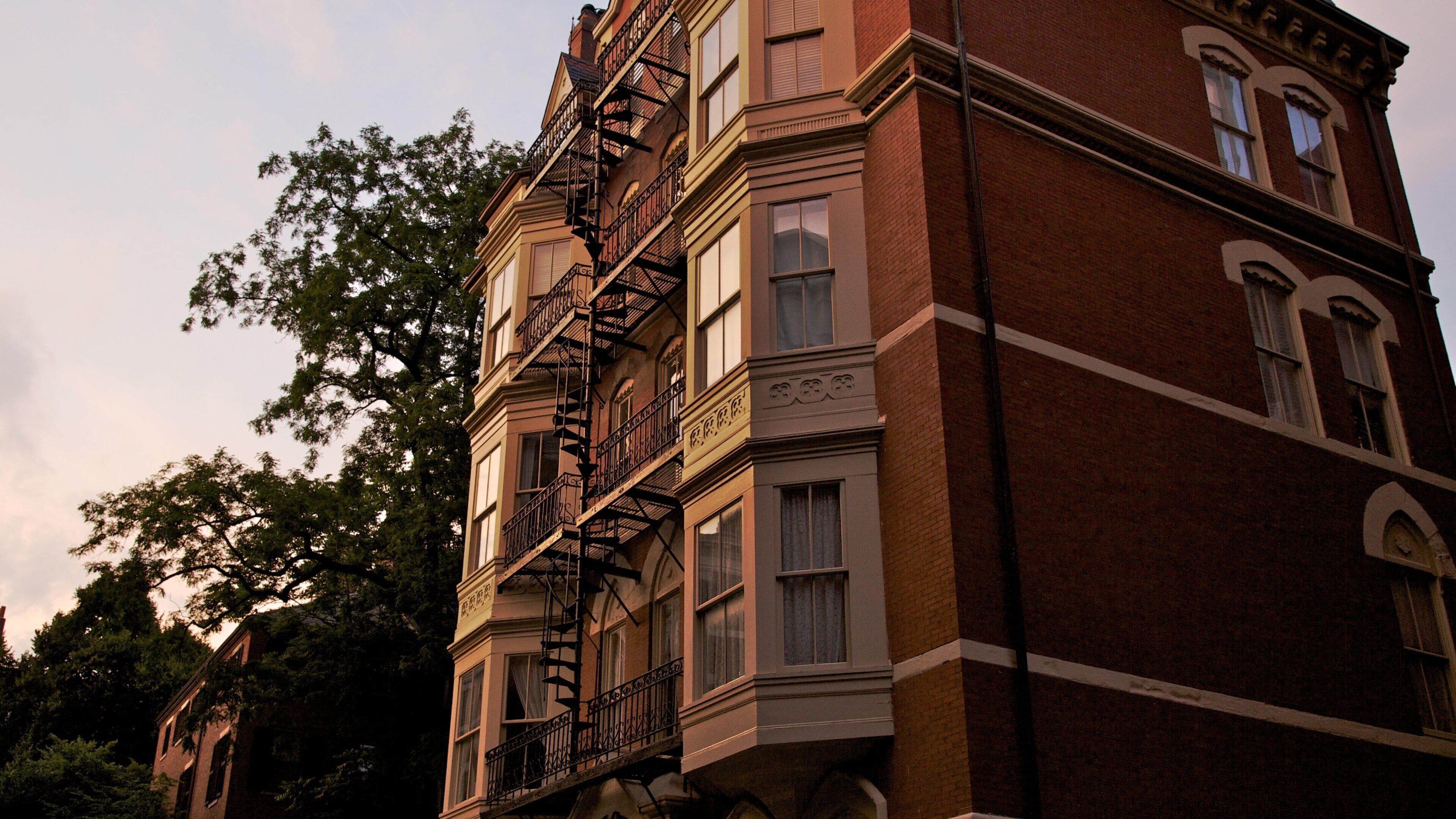 Historic architecture and serene evening in Beacon Hill, Boston, showcasing brick buildings and fire escapes