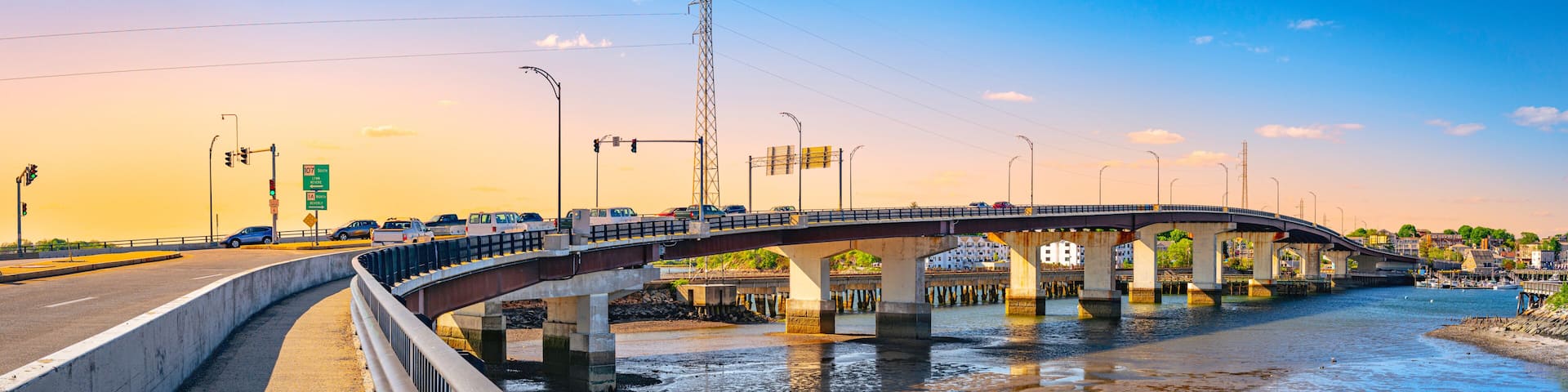 Essex Bridge over the Danvers River at low tide, next to Remond Park in Salem, Massachusetts, sunrise landscape during rush hour