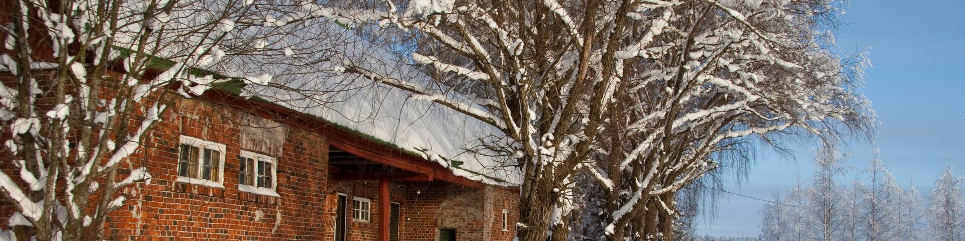 Farmhouse and frozen icy snowy trees in Hyvinkaa Finland