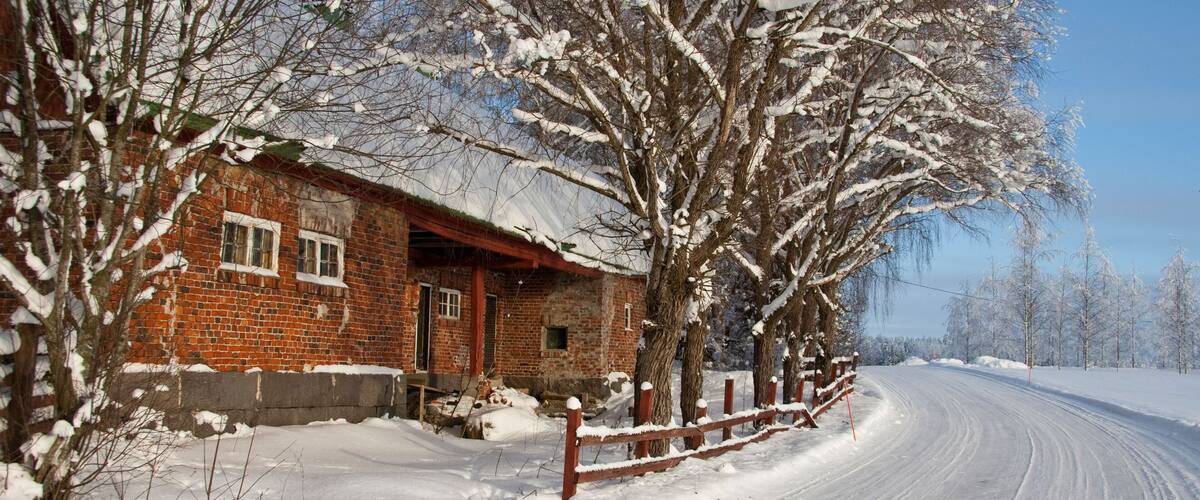 Farmhouse and frozen icy snowy trees in Hyvinkaa Finland