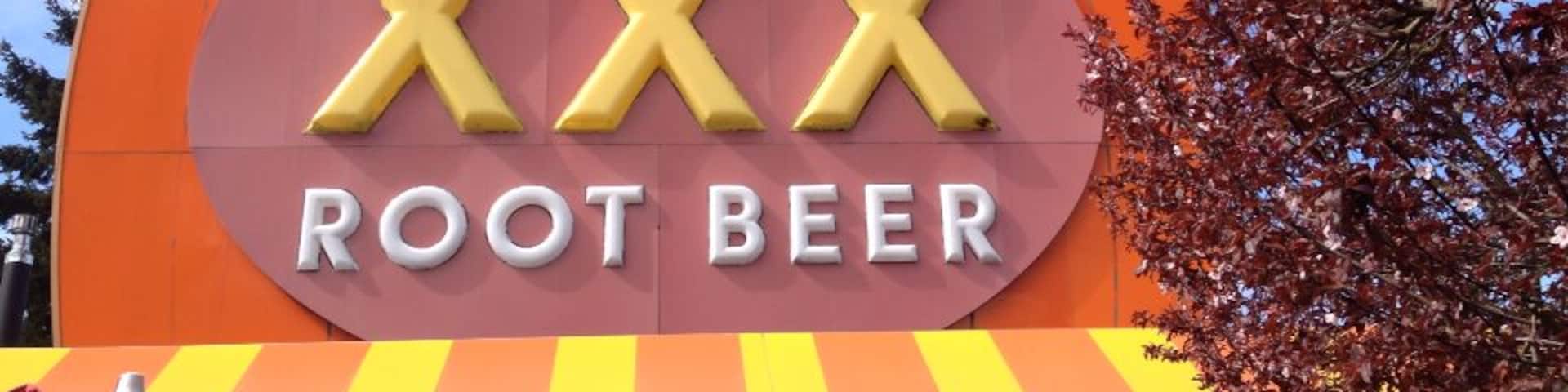 A building with a large sign that reads "XXX Root Beer".