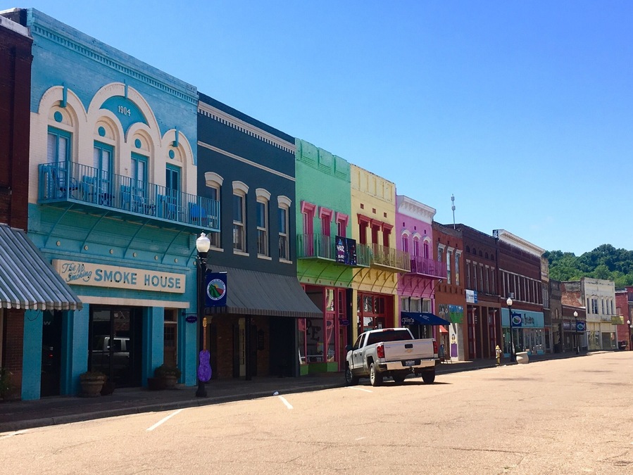 Driving through Mississippi, I had a chance to stop at Yazoo City! I instantly regretted traveling on a holiday because the downtown area looked like so much fun but everything was closed. The building are painted in bright colors and there are plywood guitars with different designs painted on them all along both sides of the road. 
There’s also a children’s area where a mural has been painted.