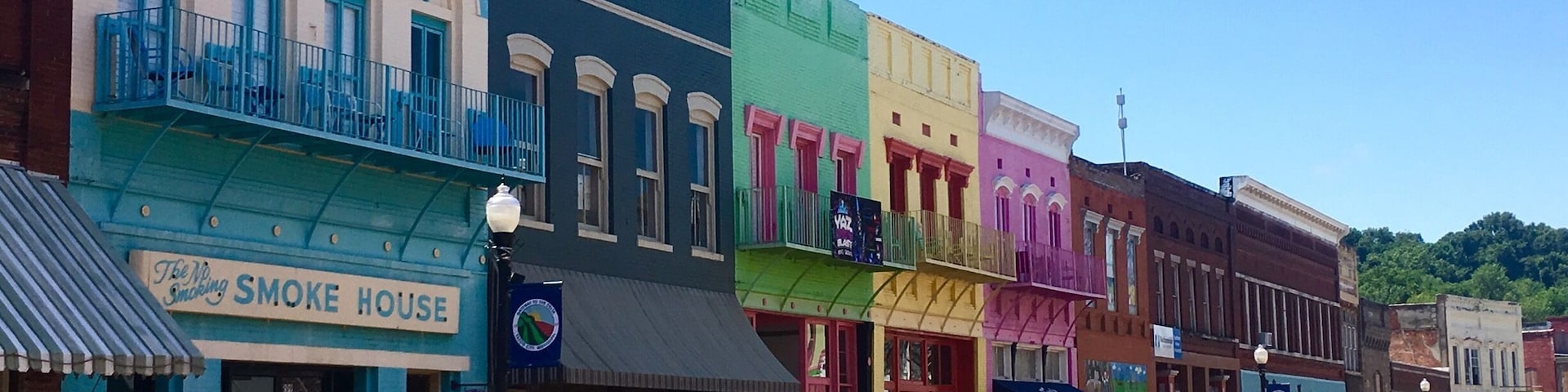 Driving through Mississippi, I had a chance to stop at Yazoo City! I instantly regretted traveling on a holiday because the downtown area looked like so much fun but everything was closed. The building are painted in bright colors and there are plywood guitars with different designs painted on them all along both sides of the road.
There’s also a children’s area where a mural has been painted.