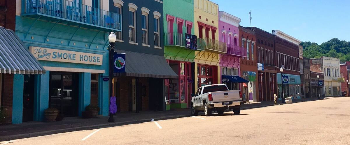 Driving through Mississippi, I had a chance to stop at Yazoo City! I instantly regretted traveling on a holiday because the downtown area looked like so much fun but everything was closed. The building are painted in bright colors and there are plywood guitars with different designs painted on them all along both sides of the road.
There’s also a children’s area where a mural has been painted.