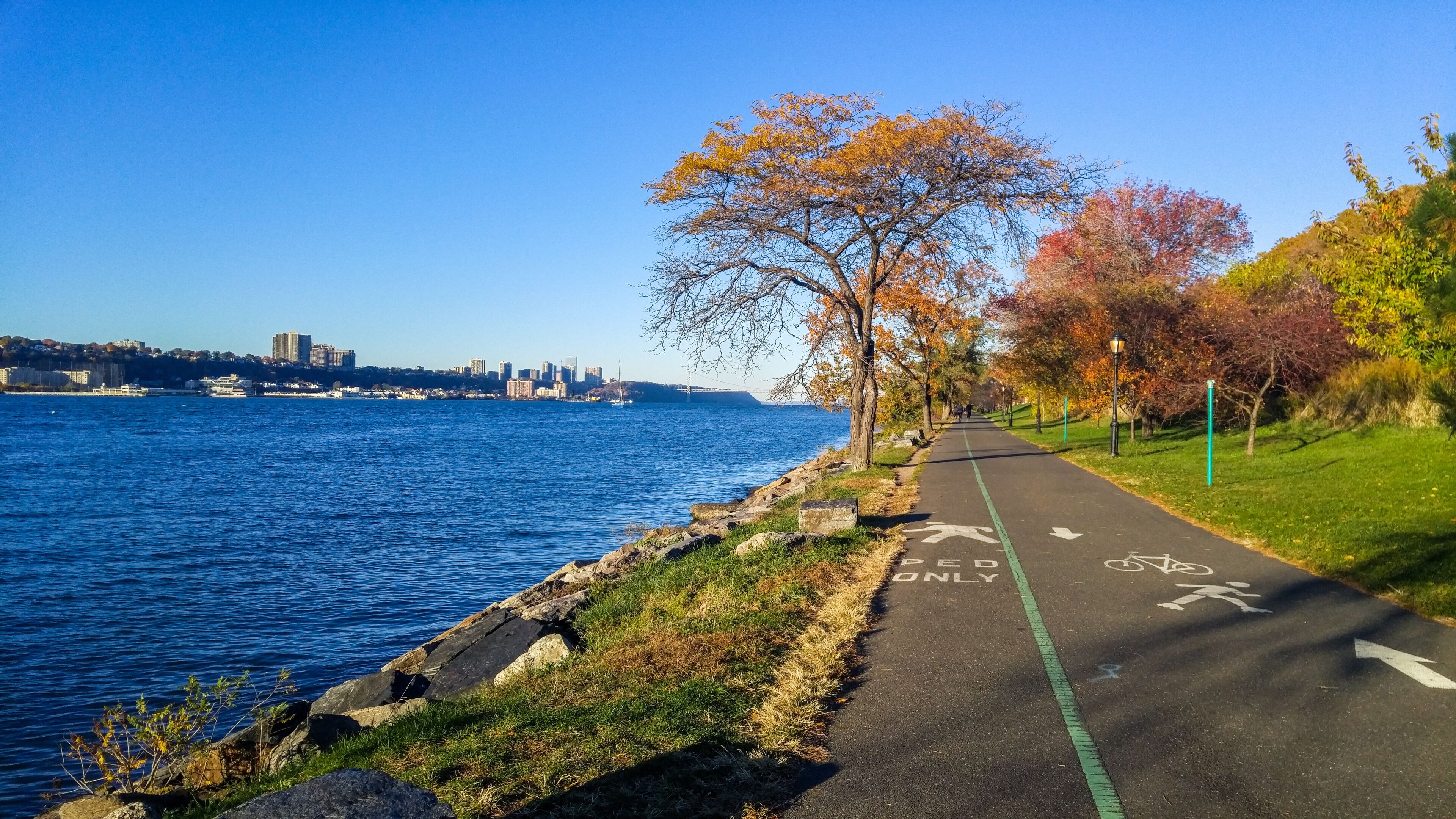 Promenade next to the Hudson River looking northward toward the George Washington Bridge, on a colorful autumn afternoon