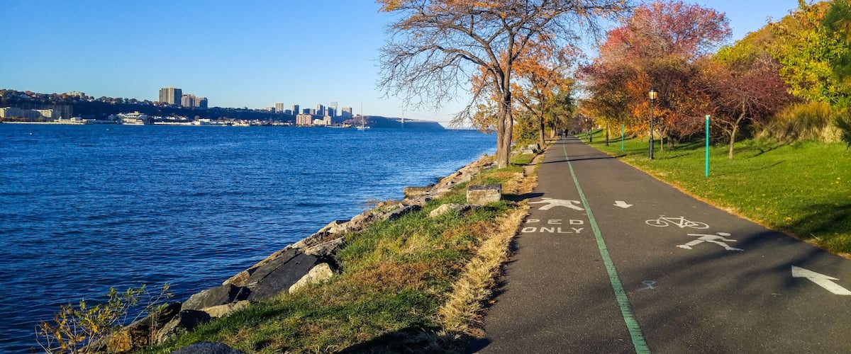 Promenade next to the Hudson River looking northward toward the George Washington Bridge, on a colorful autumn afternoon