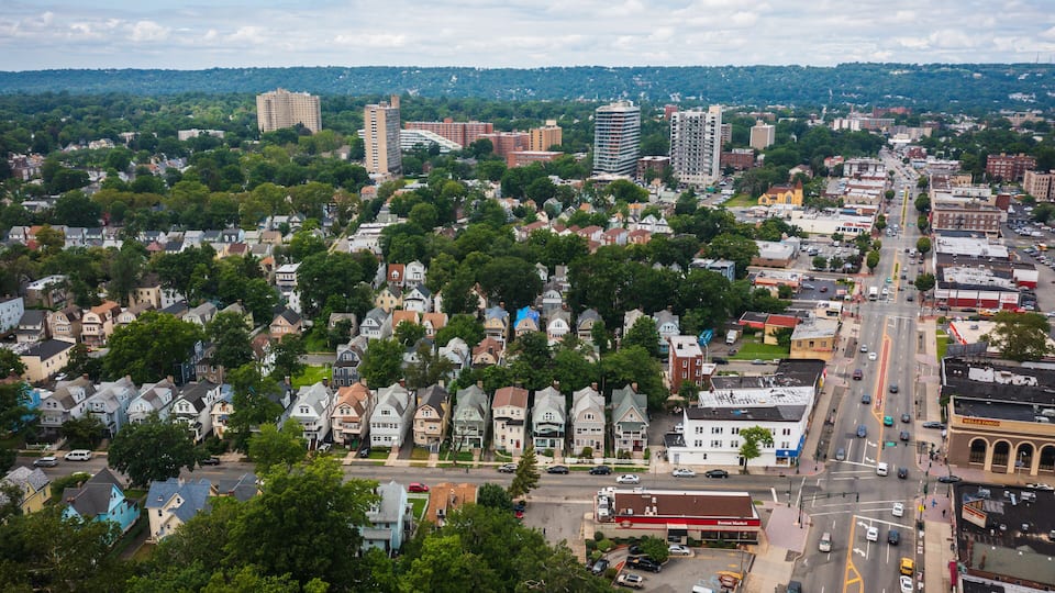 A cityscape with residential areas, commercial buildings, and a prominent bridge.