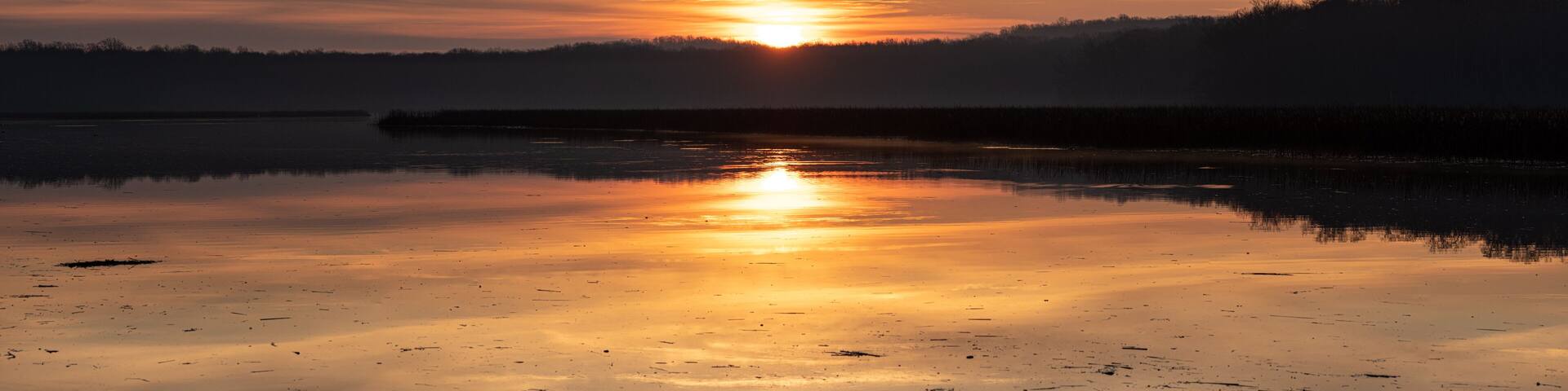 Sunrise Panorama with Colorful Sky and Horizon with Reflection in Calm River