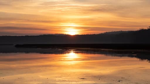 Sunrise Panorama with Colorful Sky and Horizon with Reflection in Calm River