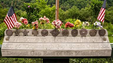 Memorial at Nature's Window Conemaugh Gap Scenic Overlook with flowers and American Flags.