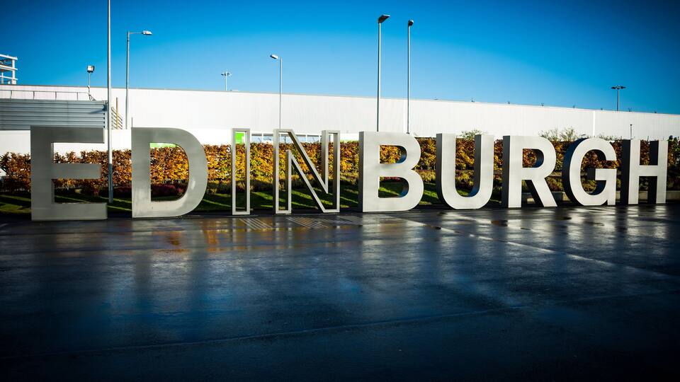 Large white letters spelling "EDINBURGH" on a building facade.