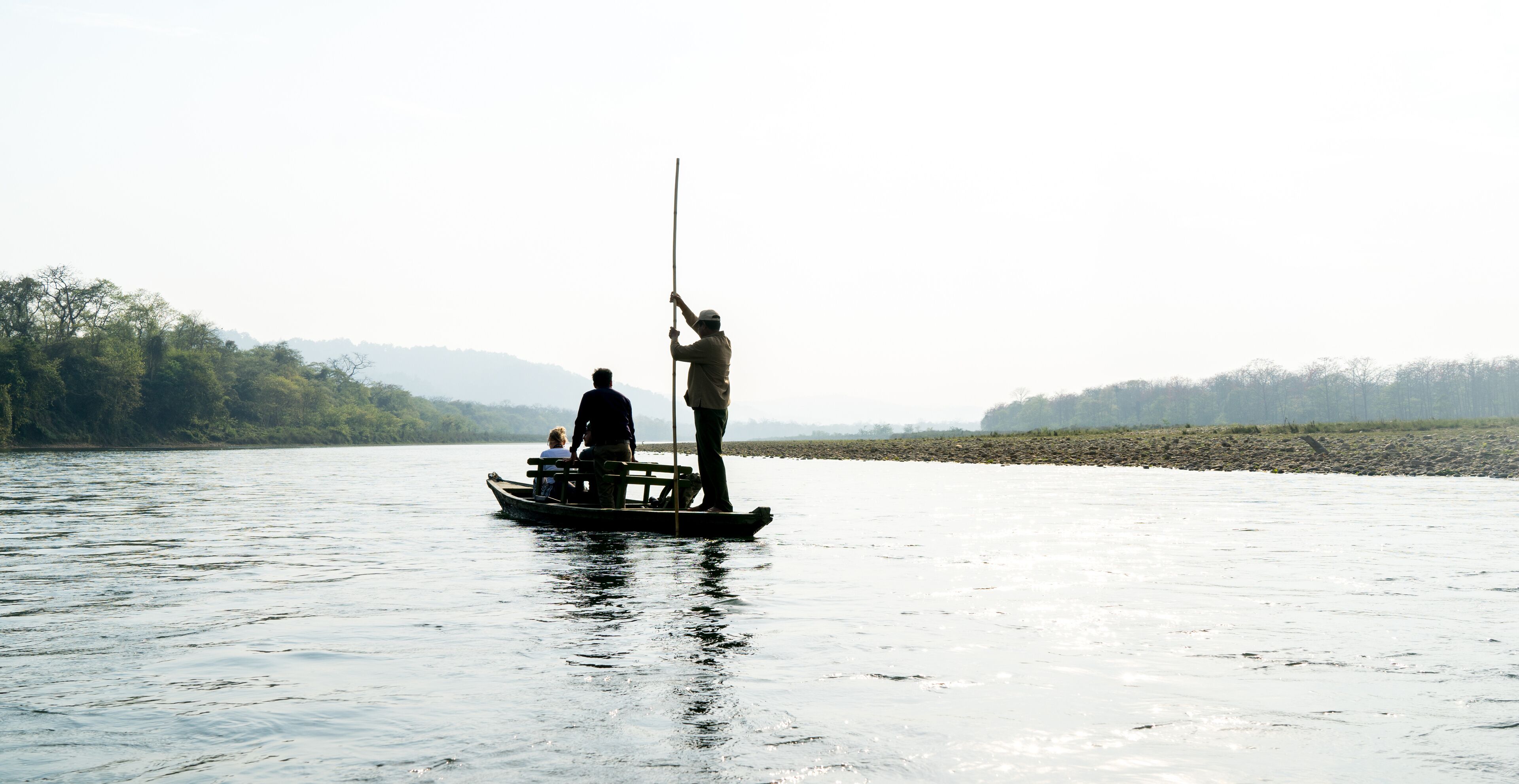 A boat trip on a silver shining river in Chitwan National Park
