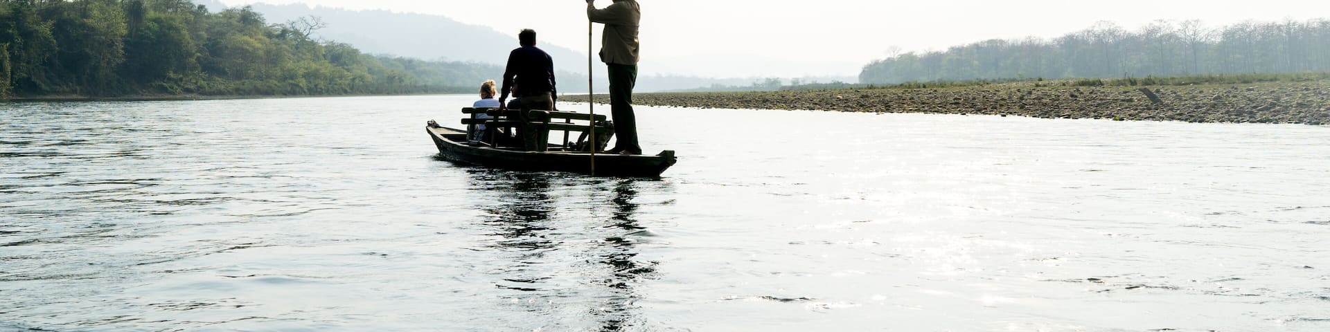 A boat trip on a silver shining river in Chitwan National Park