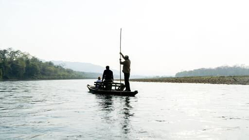 A boat trip on a silver shining river in Chitwan National Park