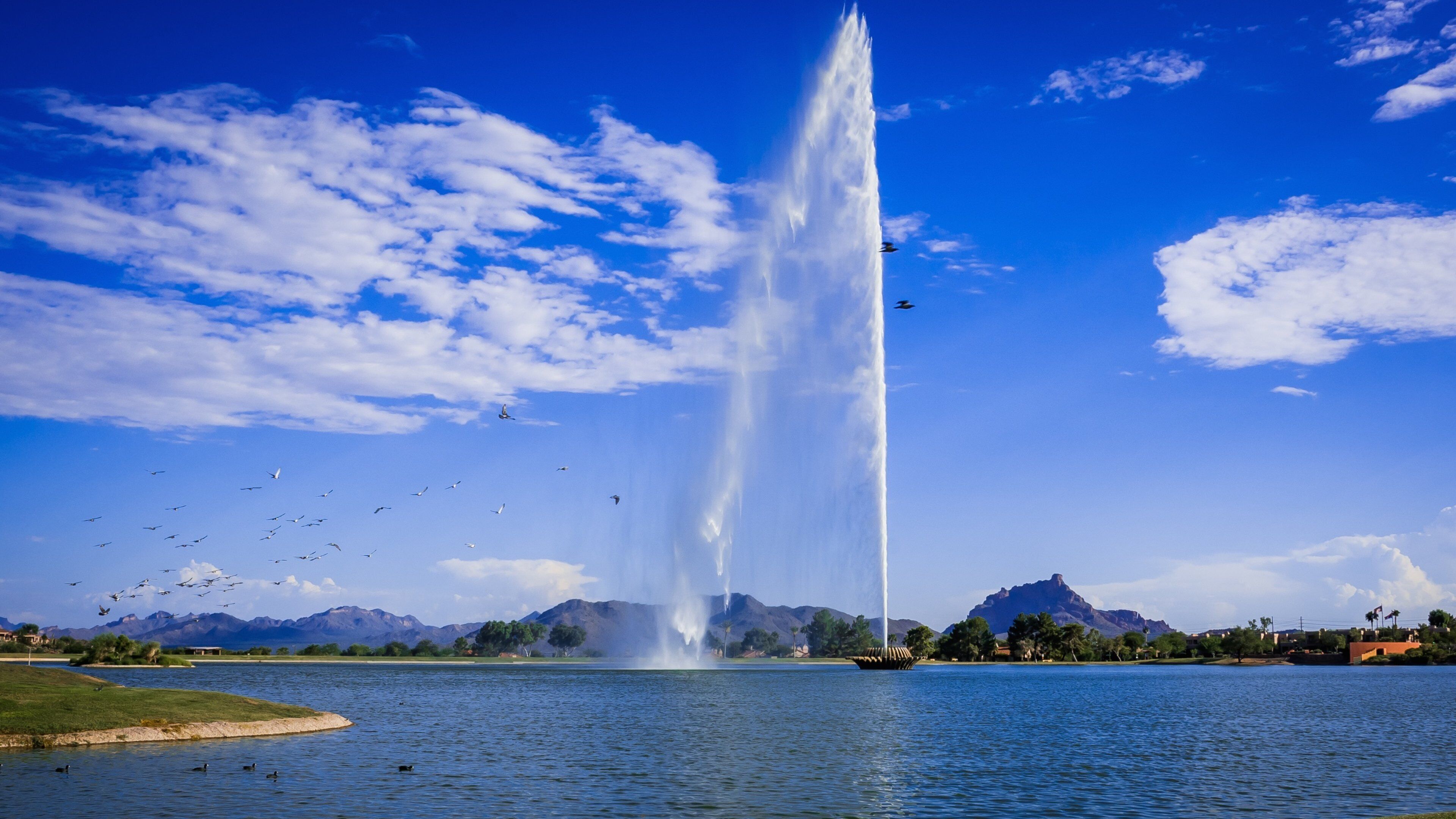 Fountain Hills featuring a lake or waterhole, mountains and a fountain