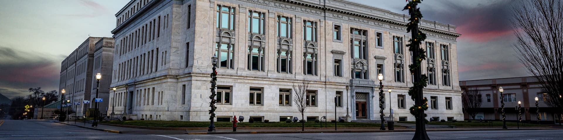 The Madison County Courthouse in Edwardsville, Illinois, during the early morning hours, with streetlights still glowing.