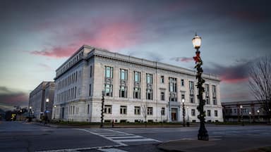 The Madison County Courthouse in Edwardsville, Illinois, during the early morning hours, with streetlights still glowing.