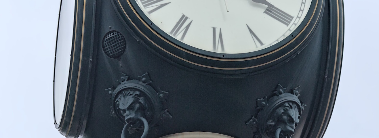 street clock detail in elmsford, new york (westchester, downtown village near tarrytown) greeburgh (ornate clock with roman numerals for hours and fancy hands) close up