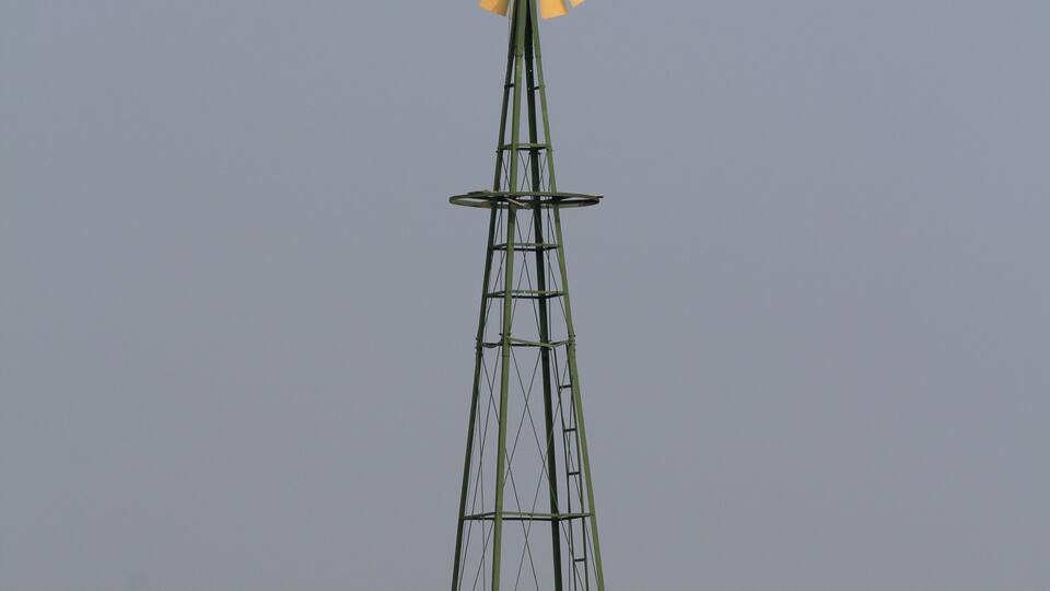 A windmill in a field.
