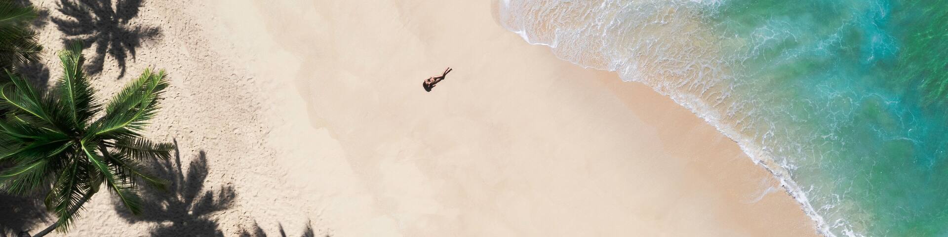 Aerial Drone View of Tropical Beach Paradise with Palm Trees and Woman