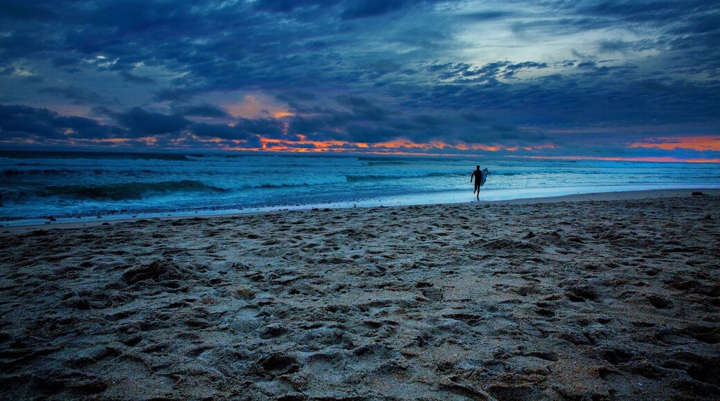 There are many things in life that are just not worth the effort. However when you have days like this one in Southern California makes everything effortless. But when taking this image I wasn't even interested in taking a picture because it was cold and windy. When I saw this surfer run out into the weather conditions I found the image I was looking for!