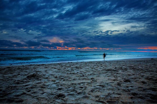 There are many things in life that are just not worth the effort. However when you have days like this one in Southern California makes everything effortless. But when taking this image I wasn't even interested in taking a picture because it was cold and windy. When I saw this surfer run out into the weather conditions I found the image I was looking for!