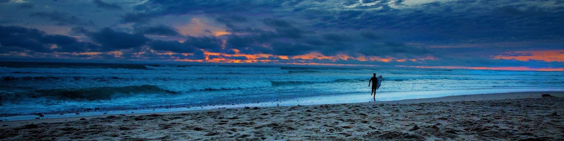 There are many things in life that are just not worth the effort. However when you have days like this one in Southern California makes everything effortless. But when taking this image I wasn't even interested in taking a picture because it was cold and windy. When I saw this surfer run out into the weather conditions I found the image I was looking for!