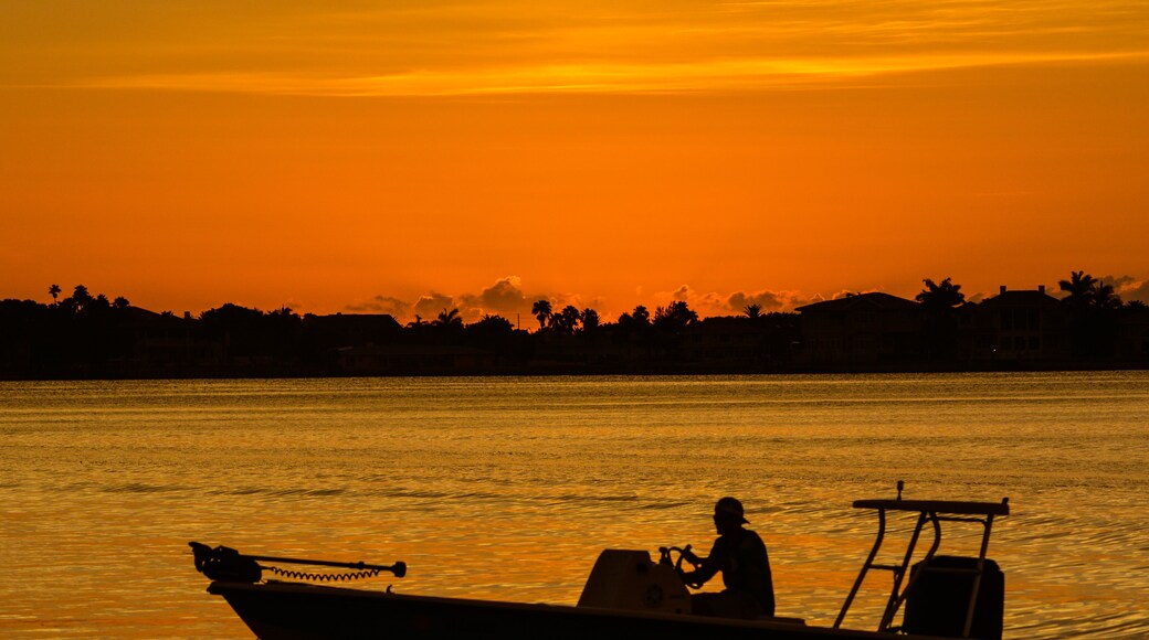 Sunset with the silhouette of a boat on the inter coastal in Belleair Bluffs, Florida