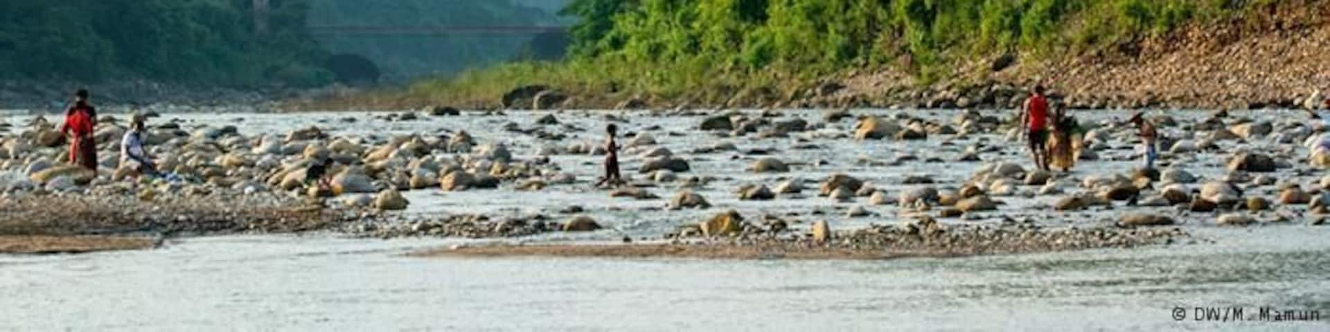 Bisnakandi is a village situated in Rustompur Union under Guainghat Upazilla. This is where many layers of the Khasi mountain meet at a single point from both sides. Flowing from above is a high fall. Adding to its charm are dark clouds hugging the mountain in the rainy season. And flowing underneath towards Bholaganj is a branch of the Piyain. Along the stream flowing from high up in the mountain come huge boulders that are deposited and mined in Bisnakandi.
http://www.visitsylhet.com/places-to-visit/bisnakandi