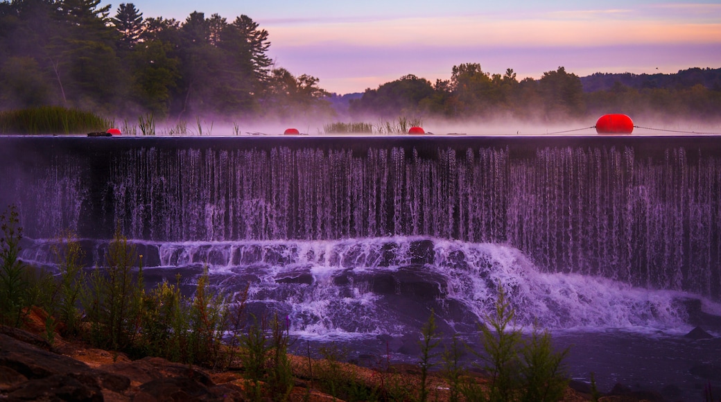 Sunrise lakeshore autumn landscape at Eagleville Pond Dam over the Willimantic River in Coventry, Connecticut