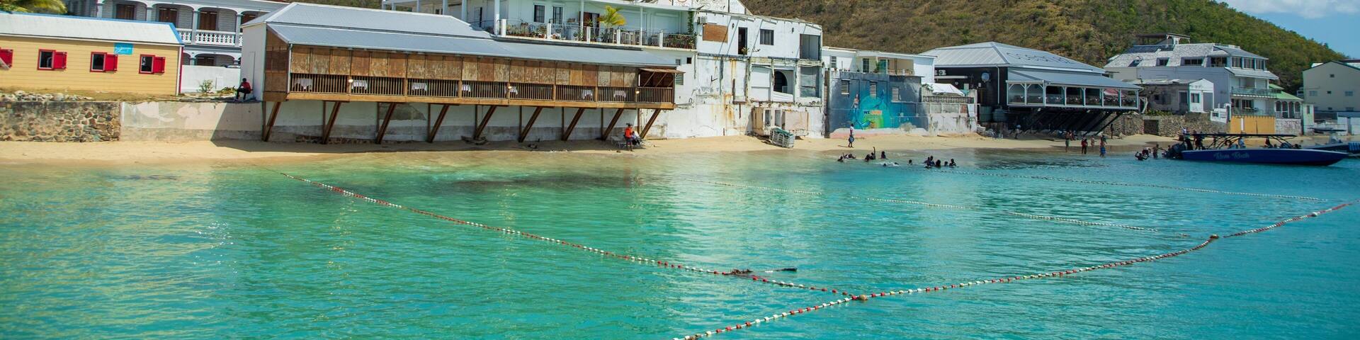 Grand Case which includes general coastal views, a coastal town and aircraft