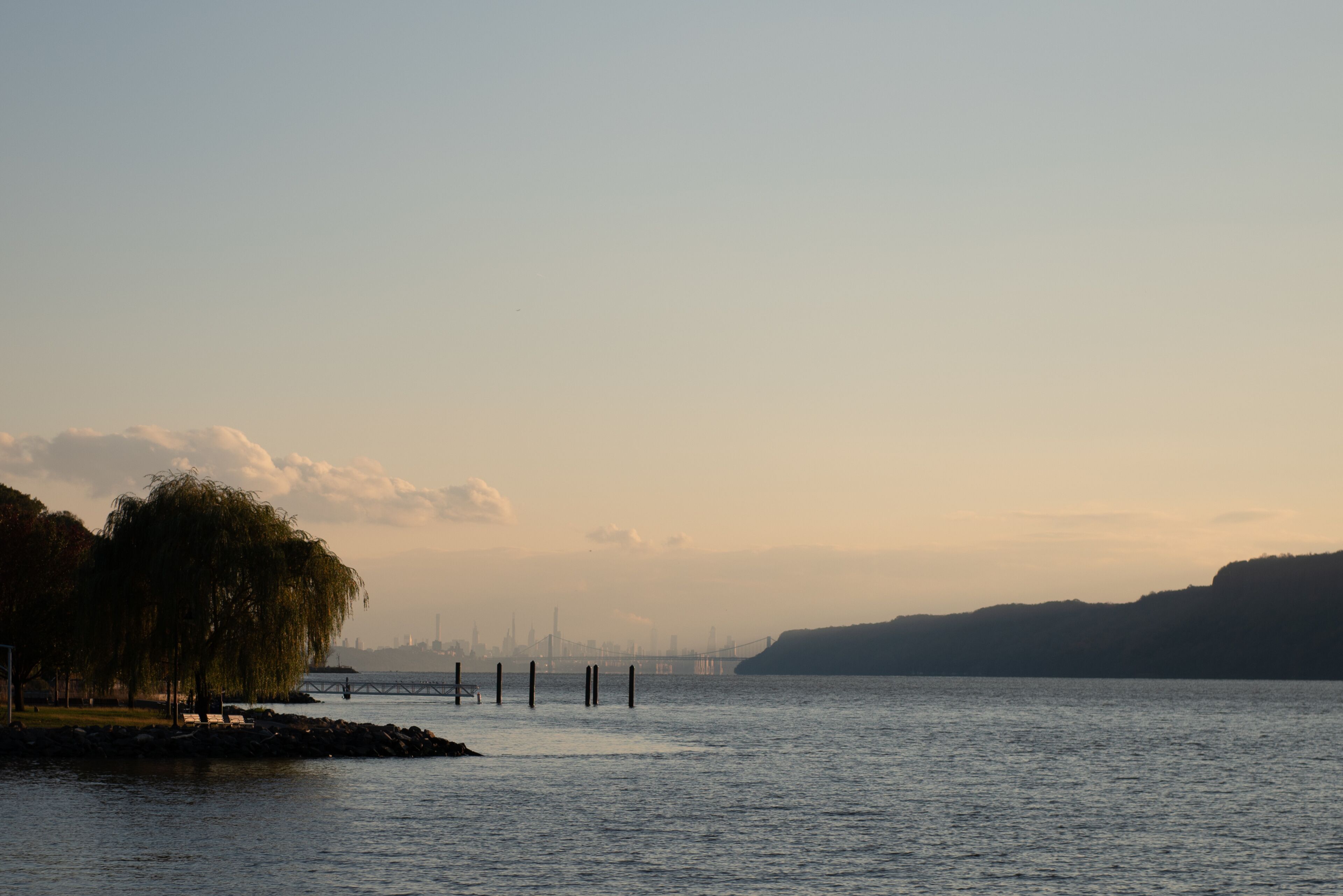 The New York City skyline, George Washington Bridge, and the Hudson River as seen from Dobbs Ferry, New York, USA in November.