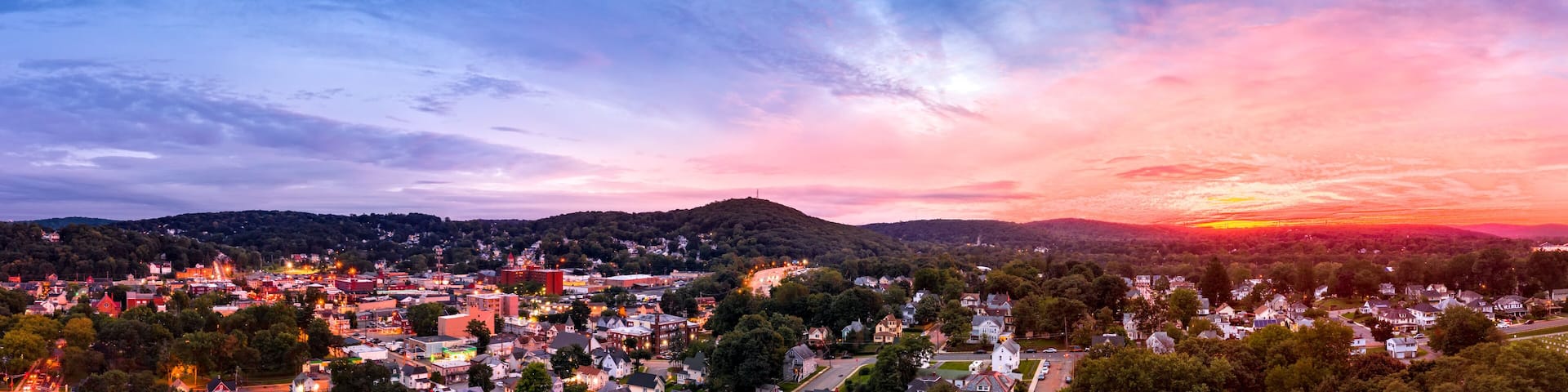Aerial cityscape of Dover, New Jersey with dramatic sky at dusk. Dover has become a majority minority community, with 70 percent of the population identifying themselves as Hispanic.
