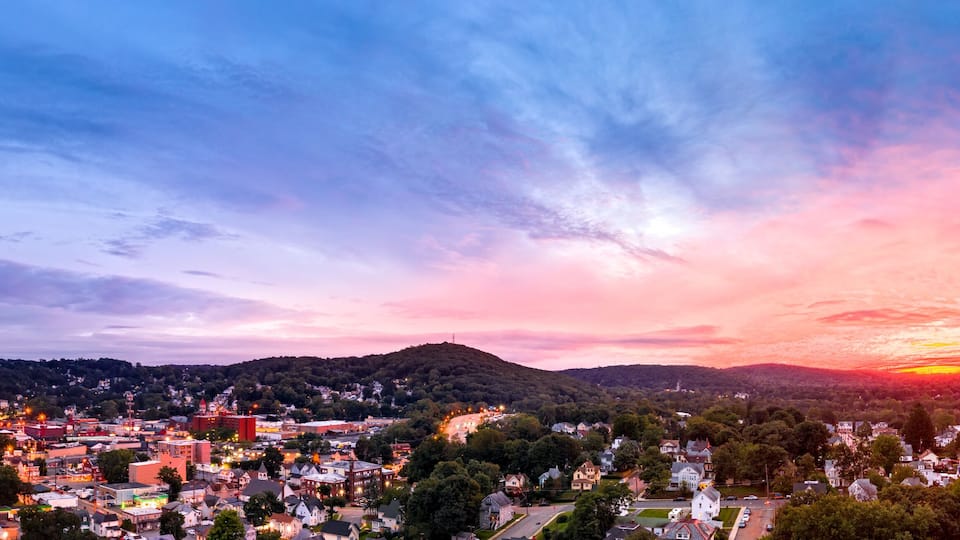 Aerial cityscape of Dover, New Jersey with dramatic sky at dusk. Dover has become a majority minority community, with 70 percent of the population identifying themselves as Hispanic.