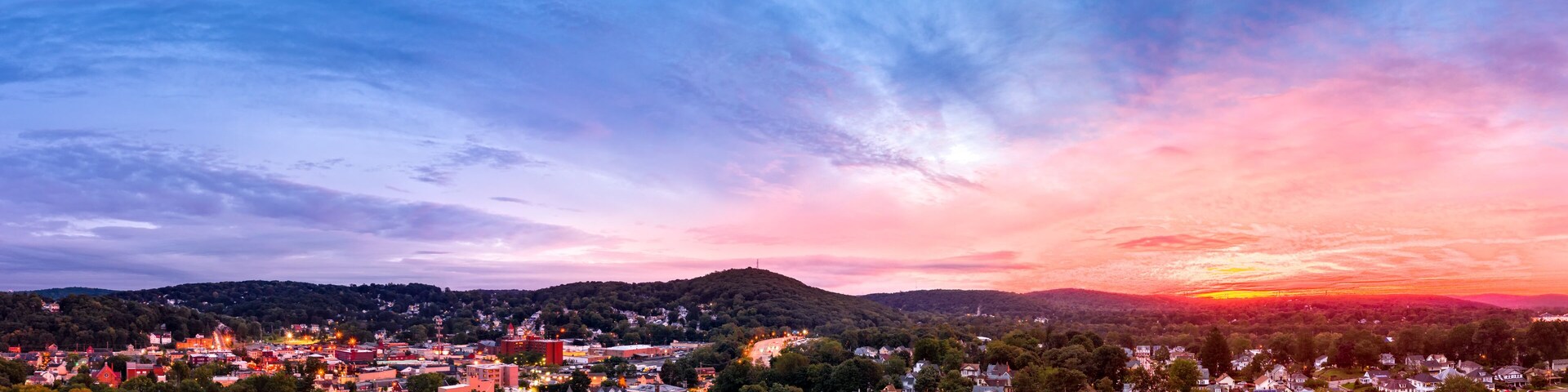 Aerial cityscape of Dover, New Jersey with dramatic sky at dusk. Dover has become a majority minority community, with 70 percent of the population identifying themselves as Hispanic.
