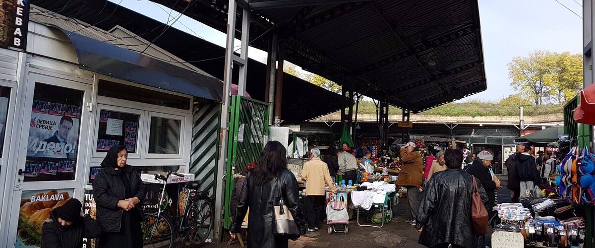 A market with a green sign reading "ЛКП. ТРЖНЦА ПИЈАЛА ТВРБАВА".