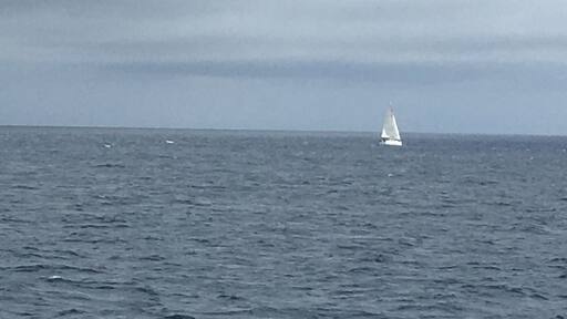 The lone sail boat in the waters between Pico and Horta, Azores Portugal