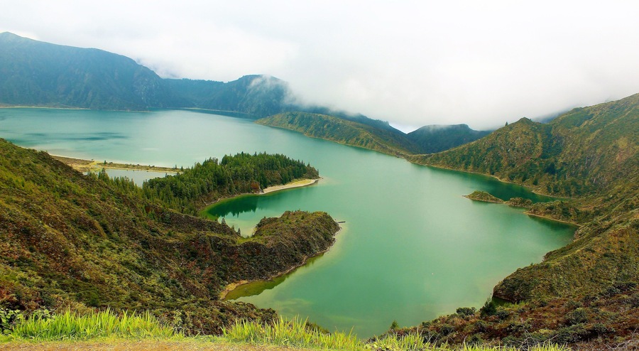 I took this in March in the Azores Islands, Portugal! It's at Lagoa do Fogo, a crater lake within the Ăgua de Pau Massif stratovolcano. This is one of the most iconic spots on SĂŁo Miguel Island! And the highest lake on the island, too. And I was there on a beautiful misty day :). In fact, I liked it so much there I visited it twice! It's incredible to be high up, but also down at the lake too which I was :). There is so much pristine beauty here. As in most of this island!