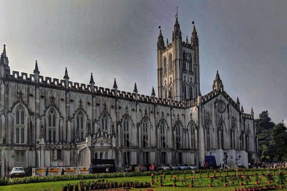 A large Gothic-style cathedral with a tall tower and intricate facade.