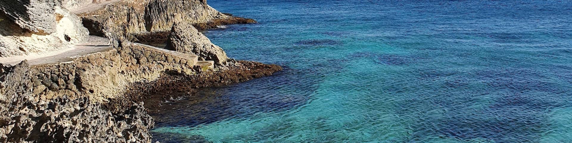 South isla mujeres, below the Mayan temple of Ixchel, you can find "secret" stairs that will take you to a rock road surrounding the south end of the island. If the sea is calm, like today, you can swim in crystal clear waters surrounded by small fish. #lifeAtExpediaGroup