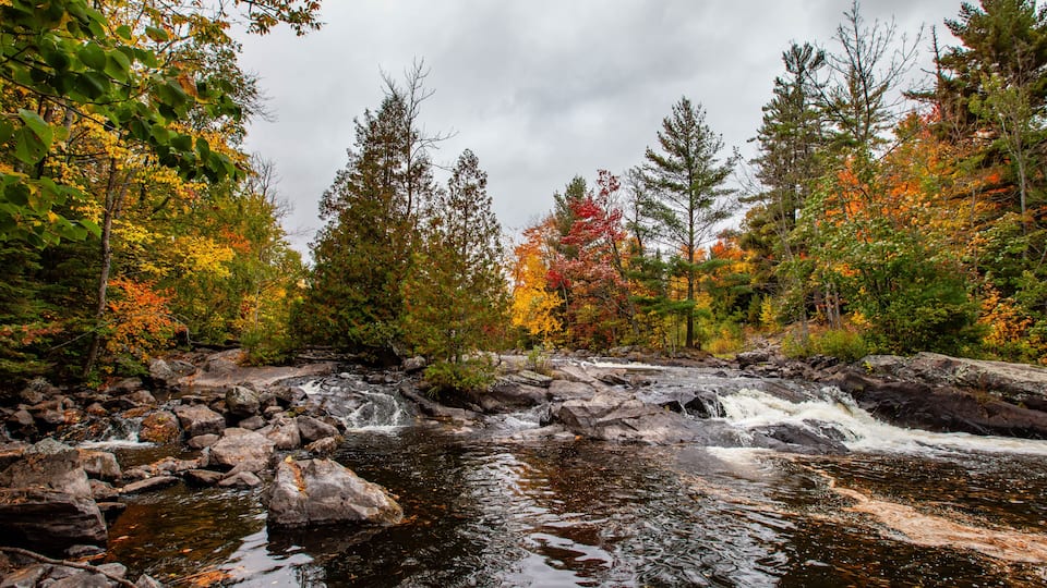 Waterfalls flowing into Lake of the Falls in Mercer, Wisconsin in September