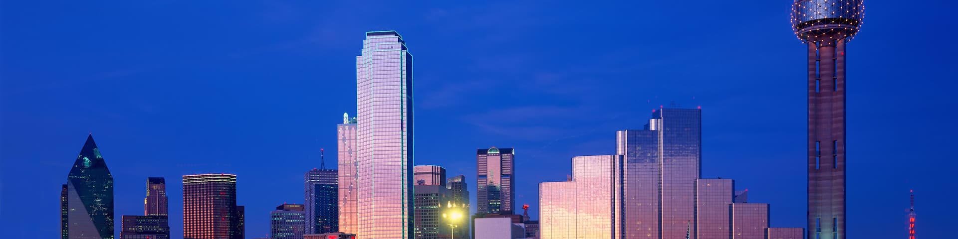 Panoramic View of Dallas, TX skyline at night with Reunion Tower