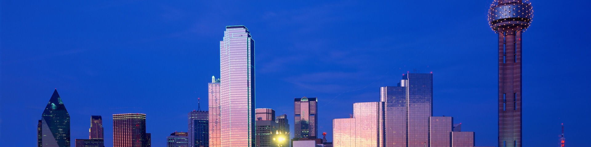 Panoramic View of Dallas, TX skyline at night with Reunion Tower