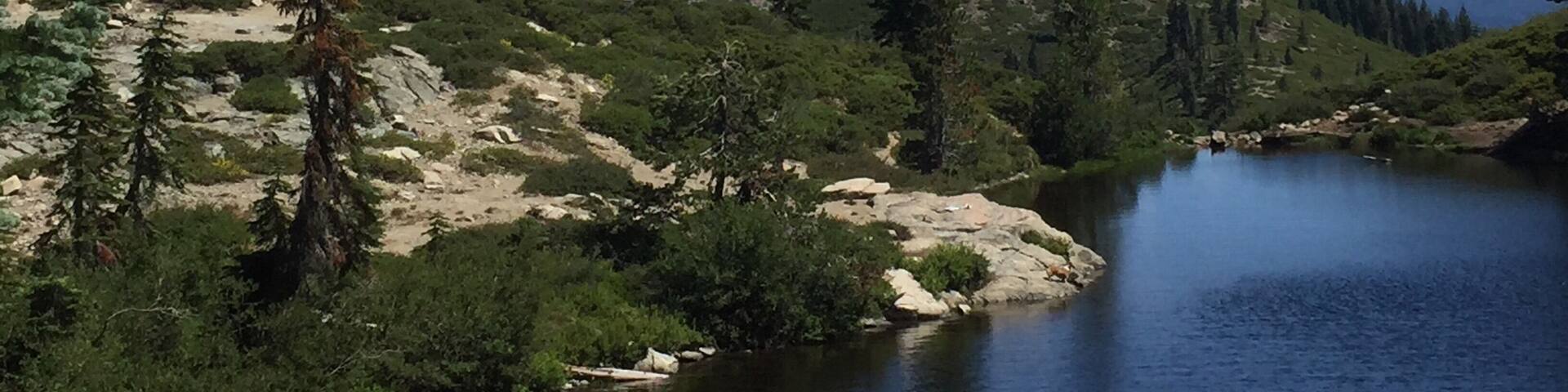 Lovely alpine lake that is shaped like a heart, looking out on Mt. Shasta.