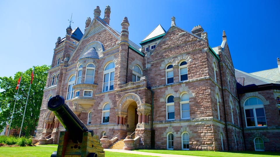 A large, historic stone building with multiple towers and arched windows.