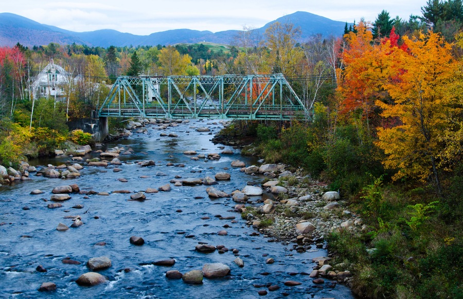 DW47GG Bethlehem New Hampshire old train bridge built in 1920 over river in Northern New England in fall foliage in October